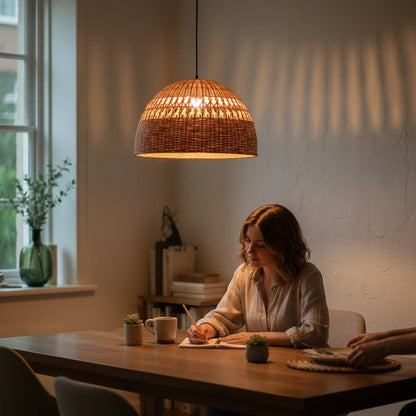 Lysverden dome-shaped pendant lamp in hand-woven natural rattan hanging over a dining table with warm ambient lighting