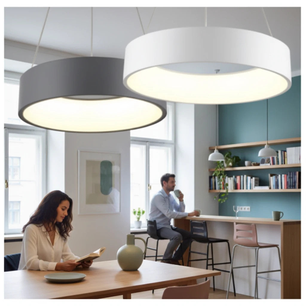 Lysverden round LED drum pendant lights in white and grey hanging over a modern living room and dining area.