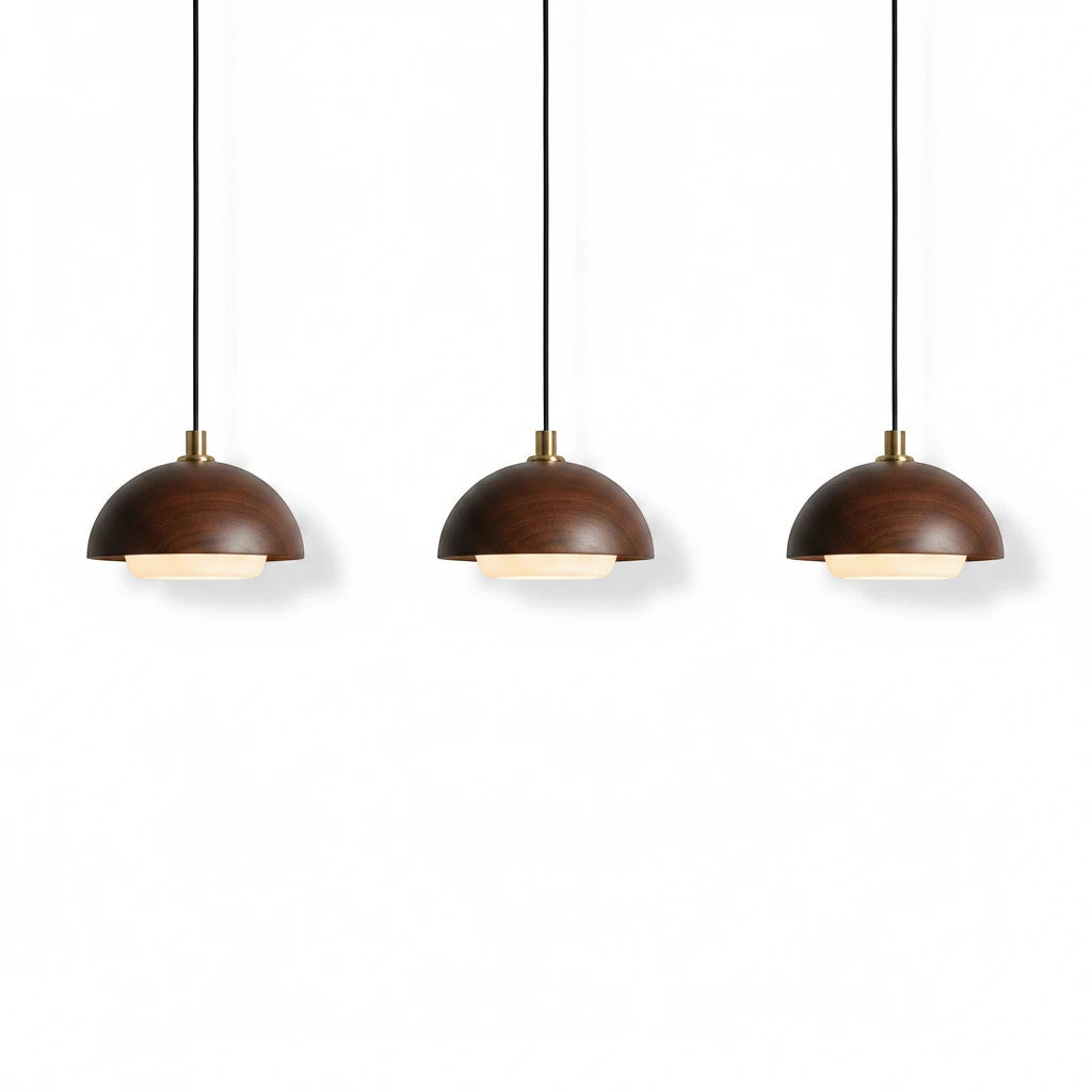 Lysverden round walnut wood pendant lights with integrated LED and brass details in a minimalist Japandi style.