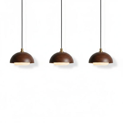 Lysverden round walnut wood pendant lights with integrated LED and brass details in a minimalist Japandi style.