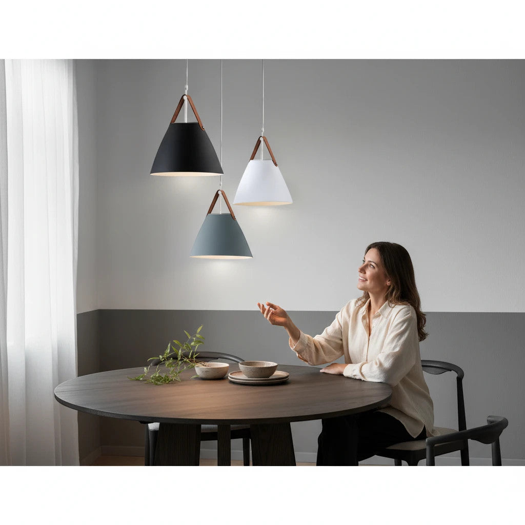 Lysverden Scandinavian pendant lights with conical metal shades and leather straps hanging over a dining table