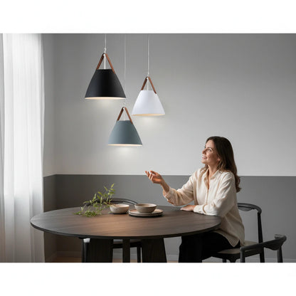 Lysverden Scandinavian pendant lights with conical metal shades and leather straps hanging over a dining table