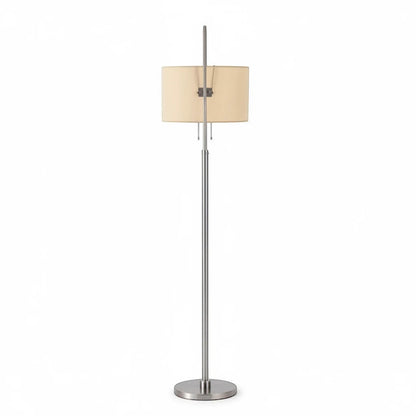 Lysverden floor lamp with a brushed silver metal stand and a beige fabric drum shade for warm ambient lighting