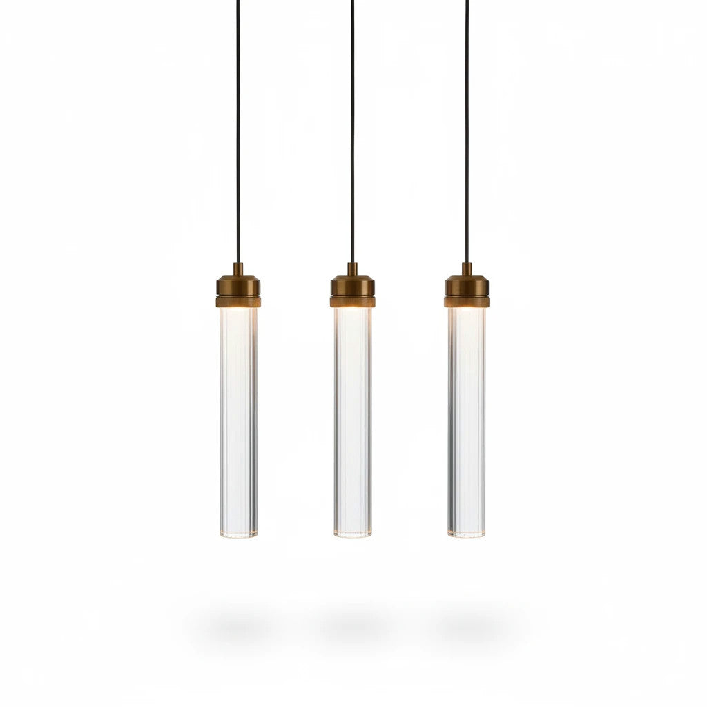 Lysverden set of three slim cylindrical LED pendant lights in transparent acrylic with elegant gold metal details.
