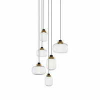 Lysverden cluster pendant light with smoke glass shades and brass accents hanging at varying heights