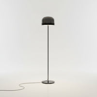 Lysverden floor lamp with a sleek metal stand and a modern dome-shaped smoked glass shade on a white background
