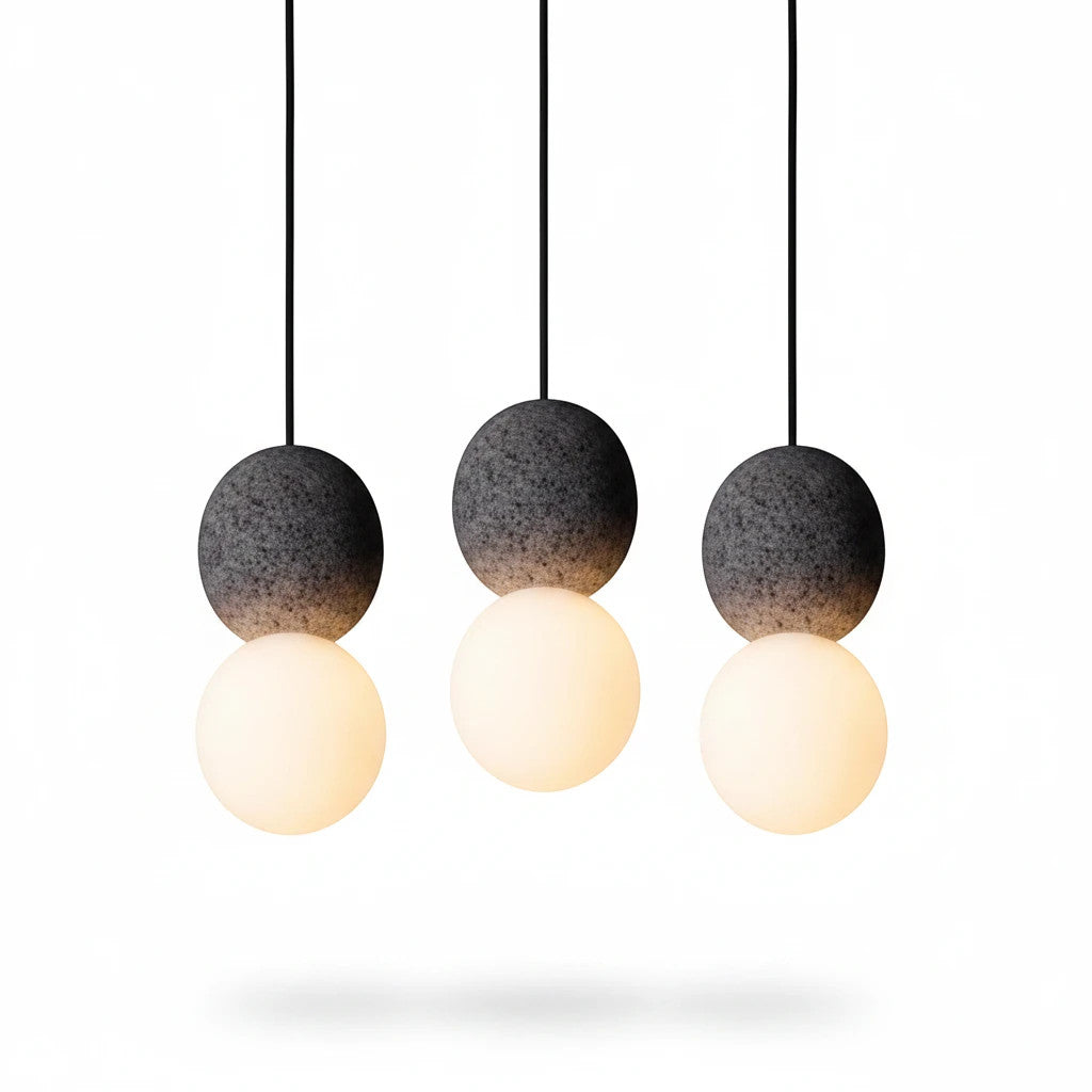 Lysverden Steinpendel trio with grey textured cement spheres and glowing opal glass globes in a Japandi style