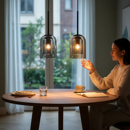 Lysverden SYLINDER pendant lamps with double smoke-grey glass shades hanging over a dining table in a cozy room.