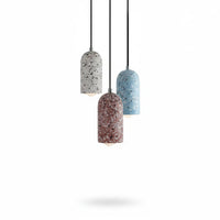 Lysverden TERRAZZO pendant lights in blue, white, and red concrete with unique stone patterns hanging in a cluster.
