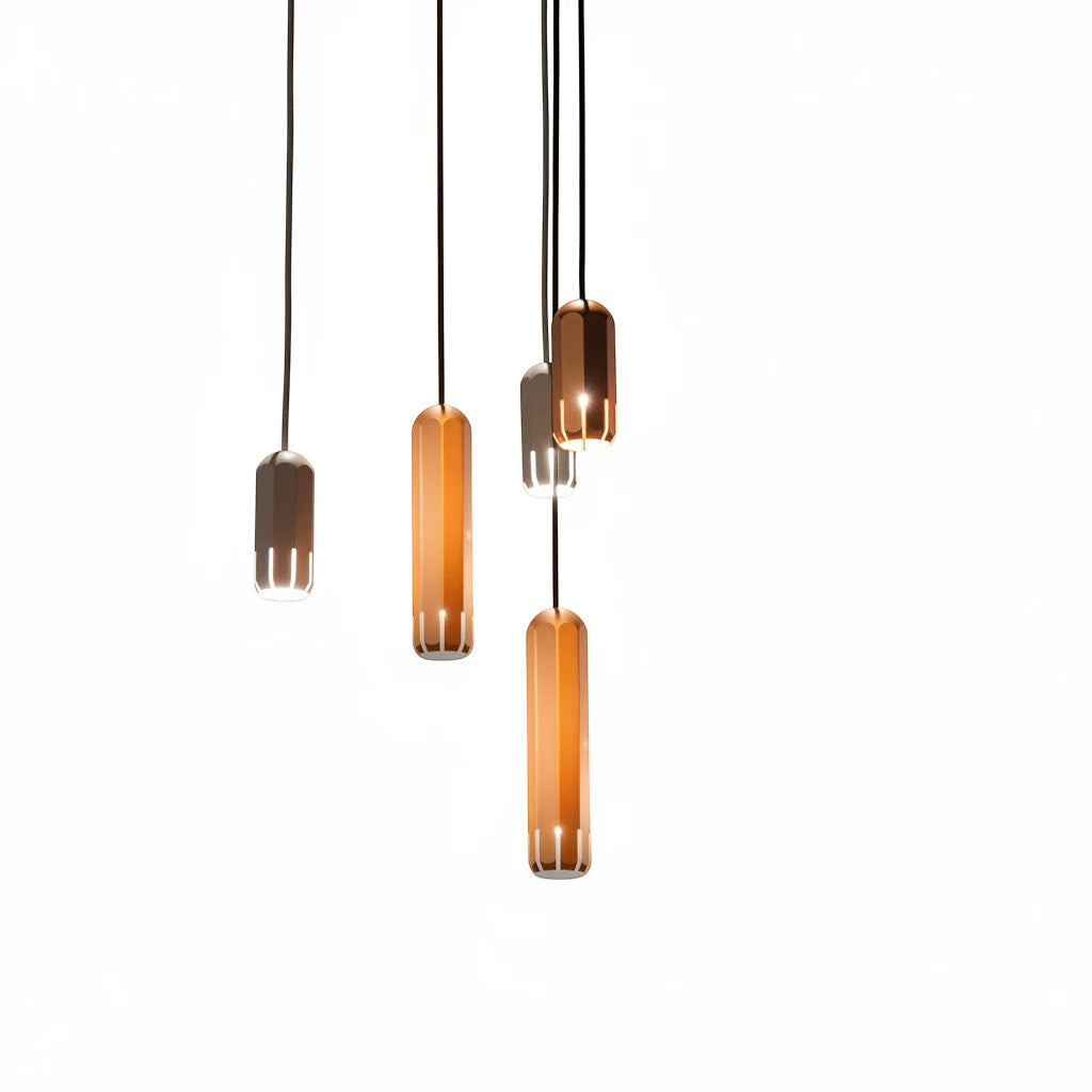 Lysverden minimalist tube pendant lights in metallic gold and grey hanging in a cluster against a white background