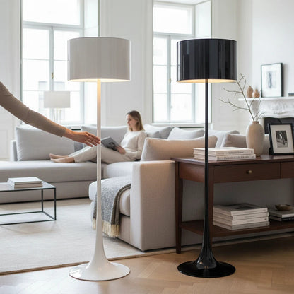 Lysverden floor lamps with tulip bases and cylindrical shades in black and white, placed in a bright modern living room.