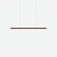 Lysverden minimalist linear LED pendant light in warm walnut wood with brass accents for modern Japandi interiors.