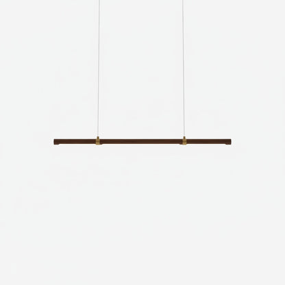 Lysverden minimalist linear LED pendant light in warm walnut wood with brass accents for modern Japandi interiors.
