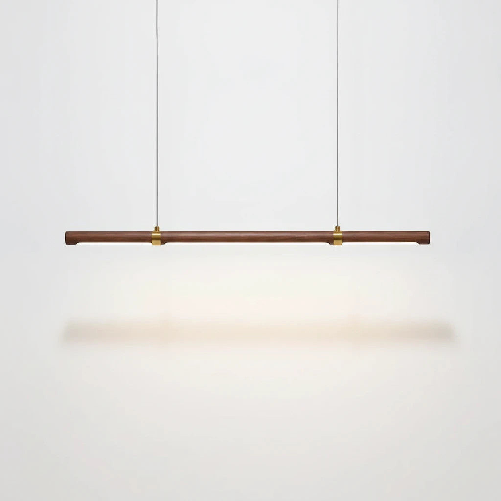 Lysverden linear LED pendant lamp in walnut wood with brass accents, minimalist Japandi style light bar.