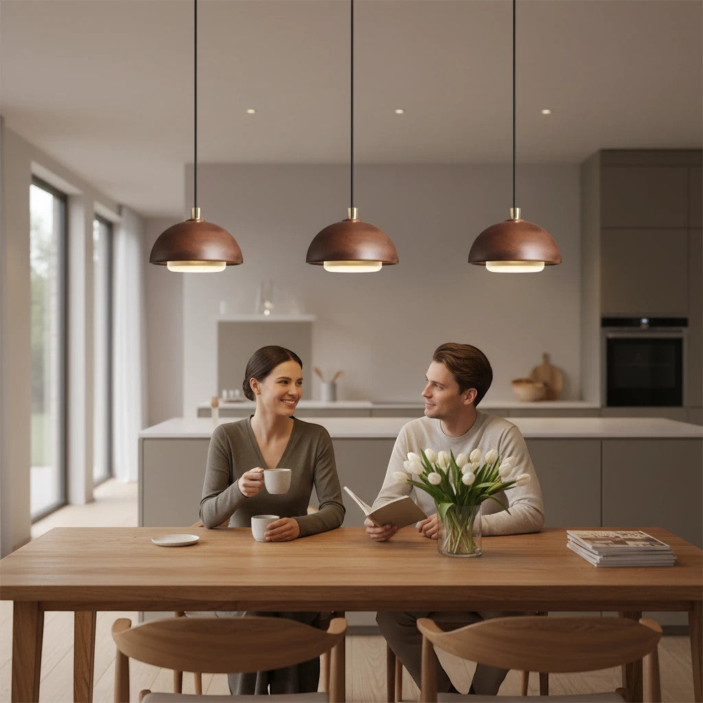 Lysverden walnut wood dome pendant lights hanging over a dining table with a couple sitting in a modern kitchen
