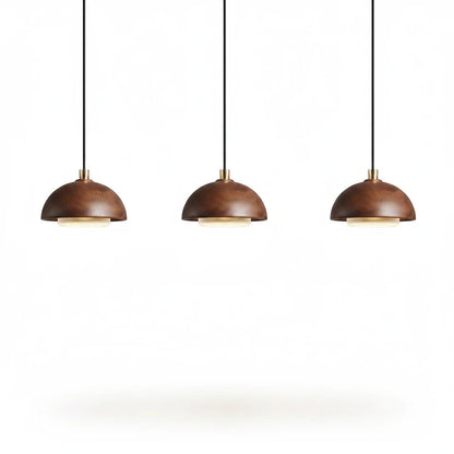 Lysverden set of three round walnut wood pendant lights with integrated warm LED lighting in a minimalist style.