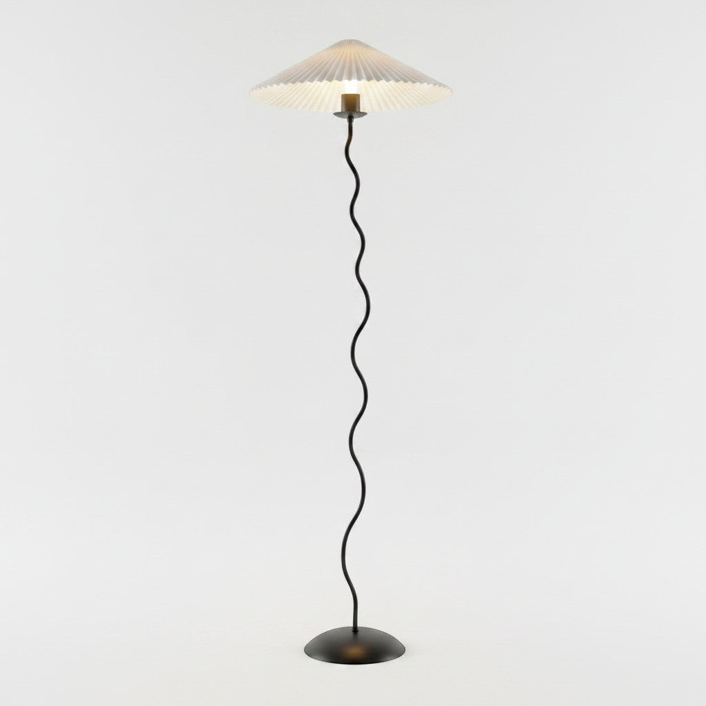 Lysverden sculptural floor lamp with a black wavy stem and a pleated white disc shade on a round base.