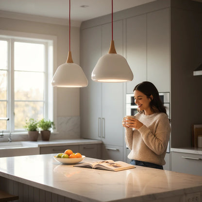 Lysverden white aluminum dome pendant lights with wood accents hanging over a modern kitchen island with a woman.