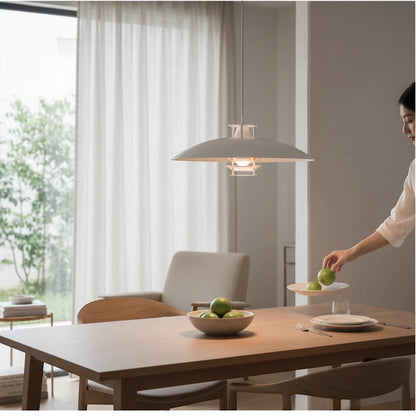 Lysverden white layered metal pendant lamp hanging over a wooden dining table in a minimalist Scandinavian interior