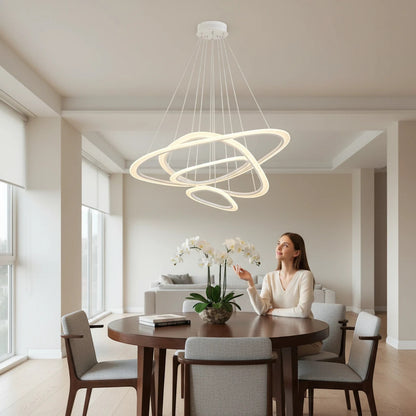 Lysverden modern white LED ring chandelier with concentric rings hanging over a dining table in a bright living room.
