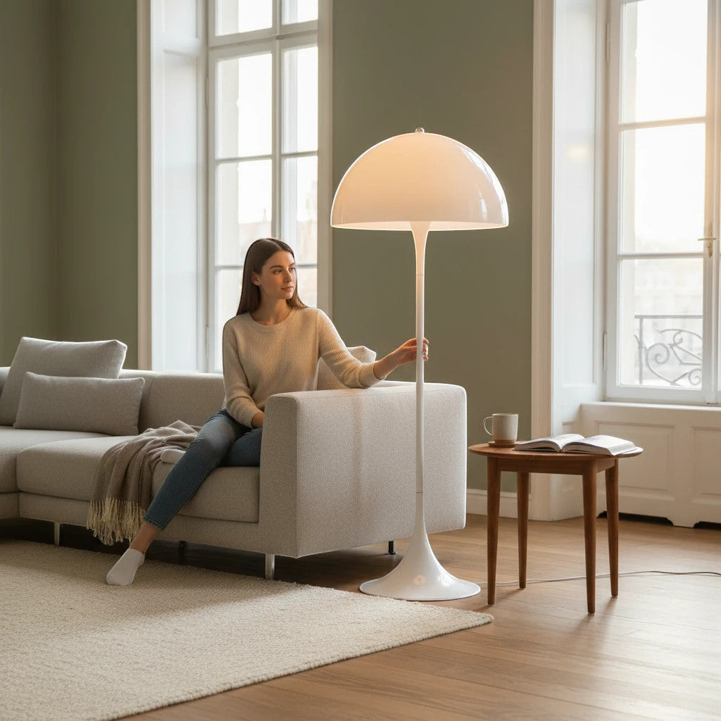 Lysverden white mushroom floor lamp with a sleek Scandinavian design standing next to a woman on a sofa in a living room