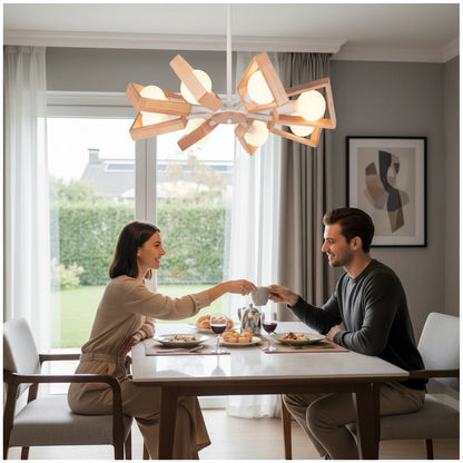 Lysverden wooden chandelier with opal glass globes hanging above a couple dining in a bright, modern living room.