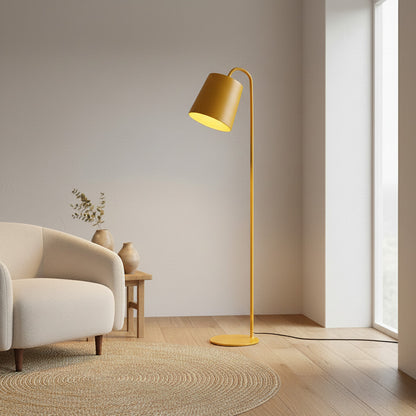 Lysverden yellow metal floor lamp with a cone-shaped shade and integrated LED standing in a modern living room.
